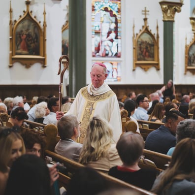 Bishop Gary at Grad Mass talking to congregation