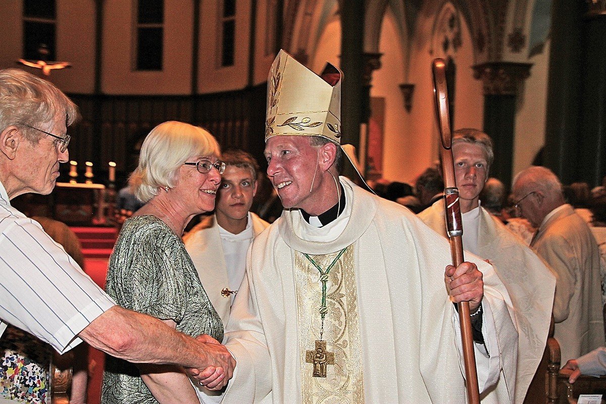 Bishop Gary Gordon shakes well-wishers’ hands at his installation as Bishop of Victoria in 2014 (B.C. Catholic file photos)