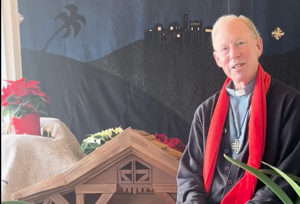Bishop Gary Gordon sitting in front of a manger scene