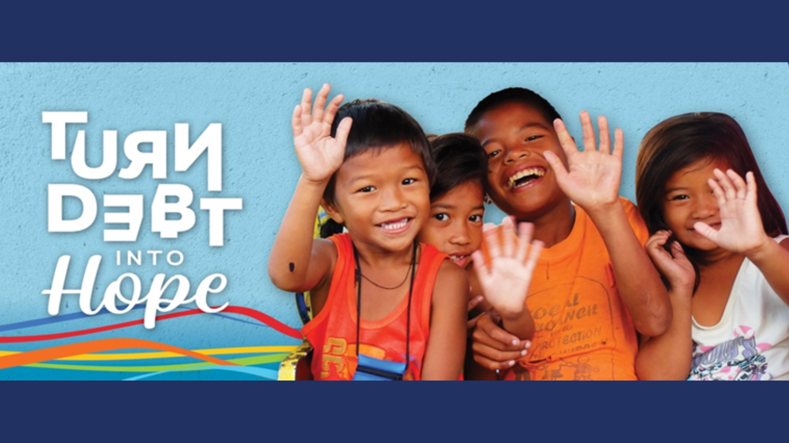 Four smiling children wave at the camera in front of a blue wall. Text on the left reads ‘Turn Debt into Hope’ in bold white letters, with colorful lines along the bottom.