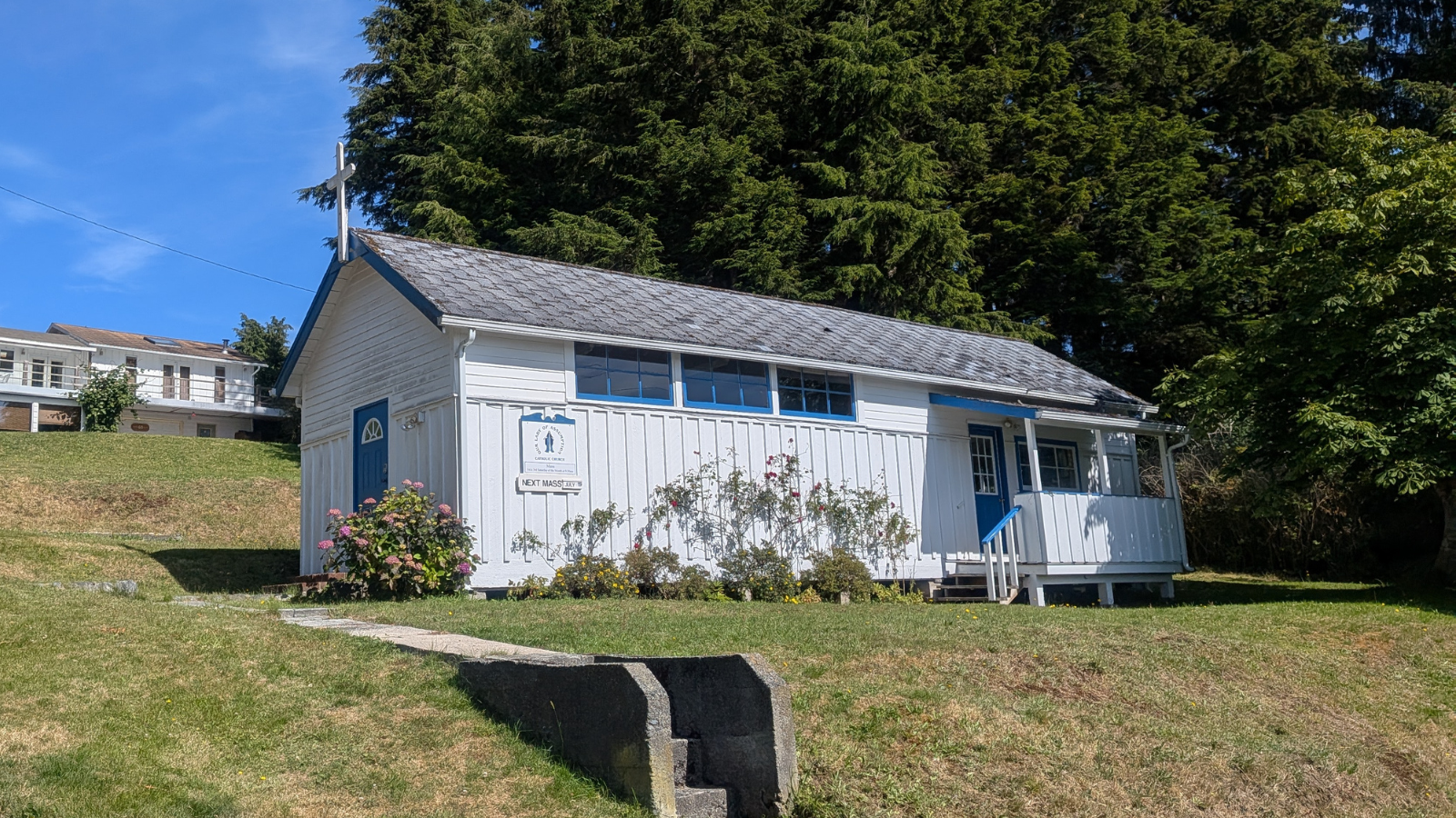 A small white chapel with blue accents, 