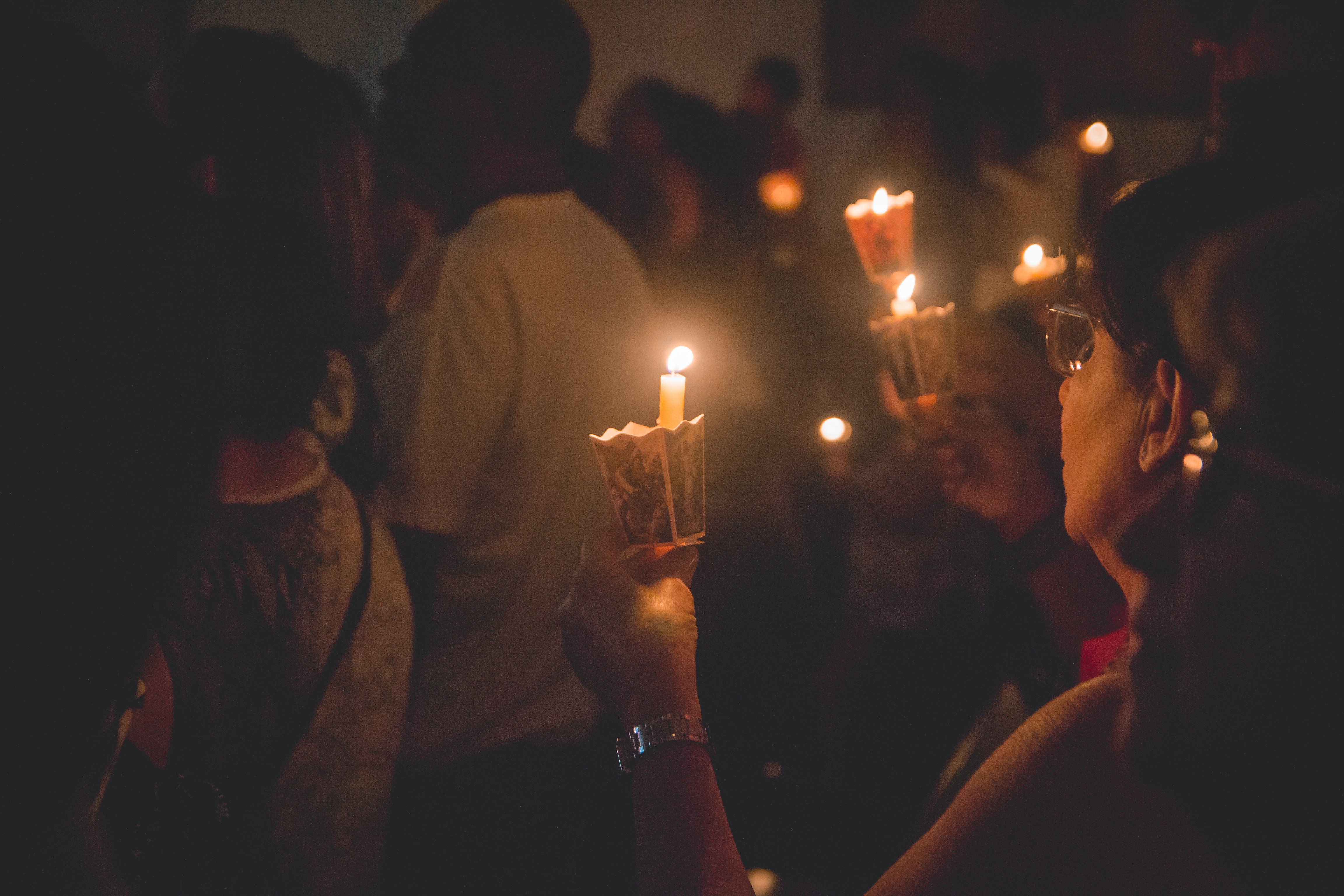 People holding lighted candles - photo by Thays Orrico on Unsplash